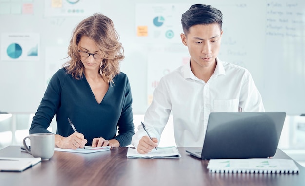 Leadership team reviewing financial reports around a meeting table